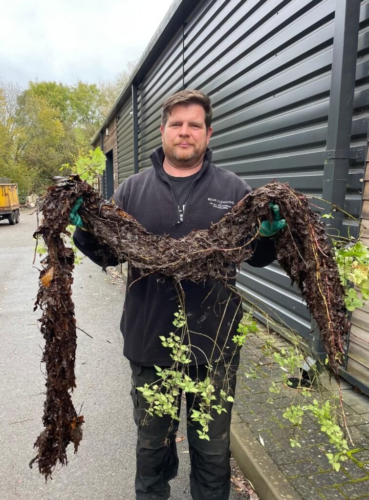 Ted from Bear Cleaning showcases the amount of dirt removed during a commercial gutter clean